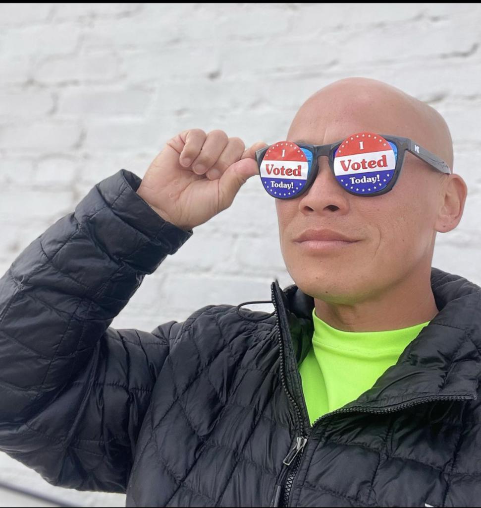 Photo of volunteer wearing "vote" sunglasses