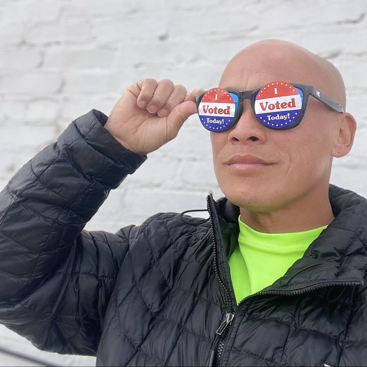 Photo of volunteer wearing "vote" sunglasses