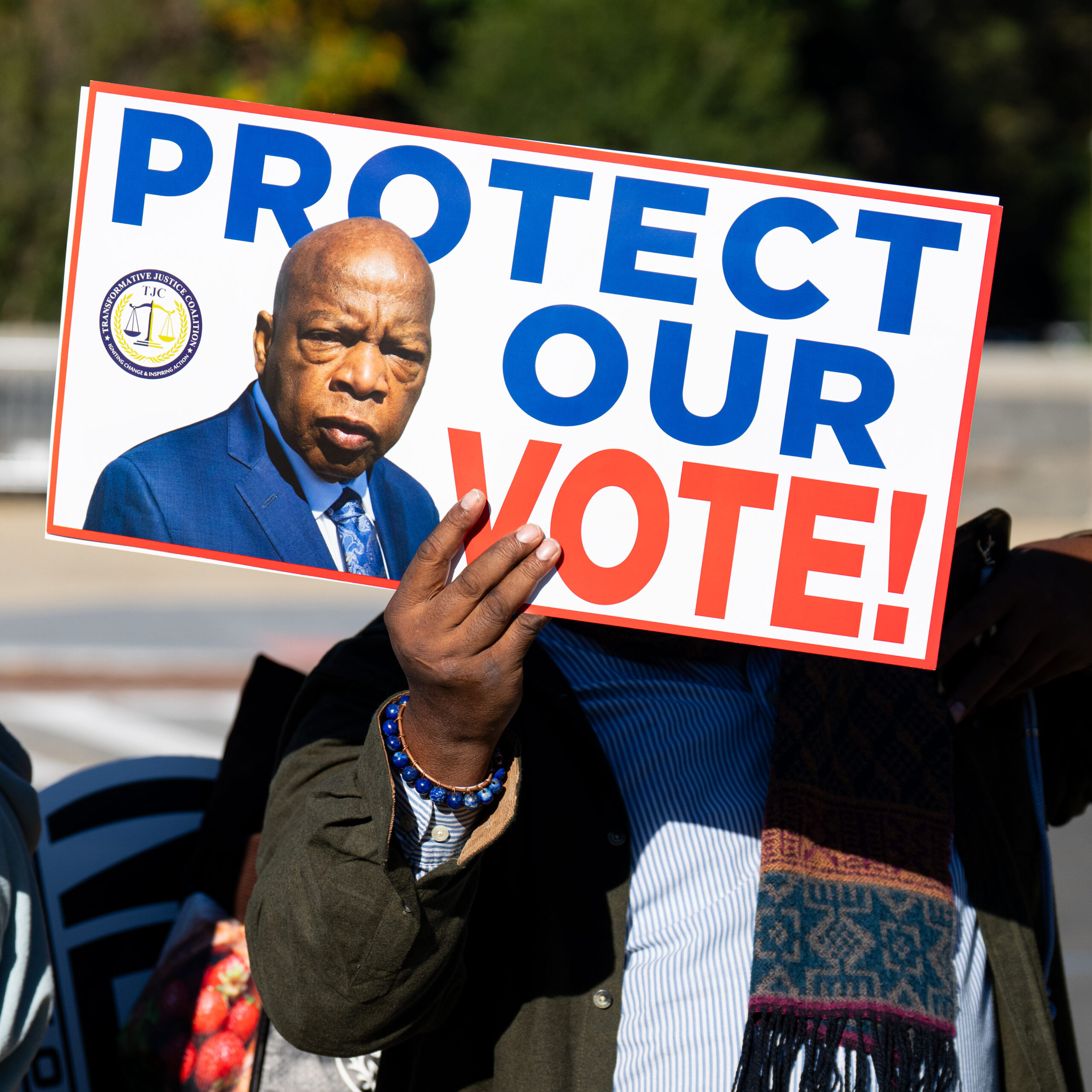 A protest sign reads 